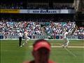 Brett Lee comes in to bowl to Cook - Original Aspect. Some dickhead in the way